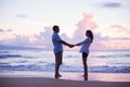 Lovers Walking on the Beach at Sunset on Vacation Royalty Free Stock Photo