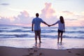 Lovers Walking on the Beach at Sunset on Vacation Royalty Free Stock Photo