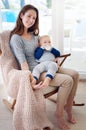 He loves being rocked to sleep with his bottle. Portrait of a mother feeding her baby boy at home. Royalty Free Stock Photo