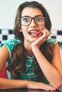 She loves making funny faces. a beautiful young woman in a diner.