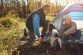 He loves the outdoors just as much as they do. a senior couple camping together in the wilderness with their dog. Royalty Free Stock Photo