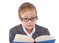 She loves reading. A little girl reading a book isolated on white. Royalty Free Stock Photo