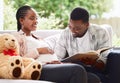 He loves reading to his unborn baby. Cropped shot of a handsome young man reading a book to pregnant wifes belly while Royalty Free Stock Photo