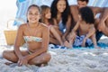 She loves spending time with her family. A family of five sitting under their umbrella at the beach. Royalty Free Stock Photo