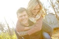 He loves to make her laugh. A happy man piggybacking his girlfriend while spending time in the woods. Royalty Free Stock Photo