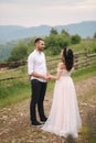 Lovestory of beautiful couple in the mountains, Handsome bearded man with beautiful and charming woman