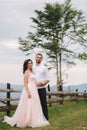 Lovestory of beautiful couple in the mountains, Handsome bearded man with beautiful and charming woman. Couple stand in