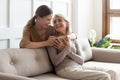 Loving adult daughter hugging older mother, enjoying tender moment