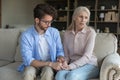 Loving adult son comforting worried concerned senior mother Royalty Free Stock Photo