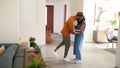 Loving African American Couple Hugging And Dancing In Hall At Home