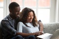 Loving African American couple using laptop together Royalty Free Stock Photo