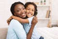 Family values. Happy afro daughter embracing her mother Royalty Free Stock Photo