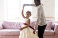 Loving african american father holding hand of adorable daughter dancing. Royalty Free Stock Photo