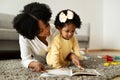 Loving african american mother reading book with her child Royalty Free Stock Photo