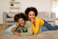 Loving African American Spouses Posing Lying On Floor At Home Royalty Free Stock Photo