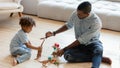 Playful biracial dad and little son play toys Royalty Free Stock Photo
