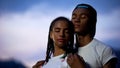 Loving african couple hugging, closing eyes to dream about happy future together