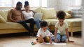 Loving african family of four spending leisure time at home Royalty Free Stock Photo