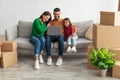 Loving Arab family using pc in their new flat Royalty Free Stock Photo