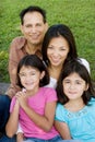 Loving Asain parents and their daughters smiling.