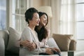 Asian adult daughter and senior mother hugging each other at home Royalty Free Stock Photo