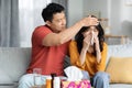 Loving asian man husband taking care of his sick wife Royalty Free Stock Photo