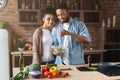 Loving black couple cooking green healthy salad