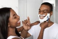 Loving Black Couple Having Fun In Bathroom, Laughing While Shaving Royalty Free Stock Photo