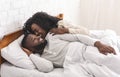 Loving black couple having fun in bed, kissing and hugging Royalty Free Stock Photo