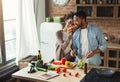 Loving black couple preparing dinner