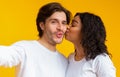 Loving Black Girlfriend Kissing Her Boyfriend`s Cheek While They Taking Selfie Royalty Free Stock Photo