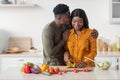 Loving Black Husband Kissing Wife While She Cooking Food In Kitchen Interior Royalty Free Stock Photo