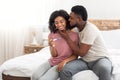 Loving black man kissing his pregnant wife or girlfriend Royalty Free Stock Photo