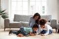 Loving black mom and little children drawing with colored pencil