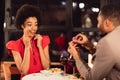 Loving Boyfriend Asking Surprised Girlfriend To Marry Him In Restaurant