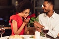 Loving Boyfriend Giving Girlfriend Bouquet Dating Having Dinner In Restaurant