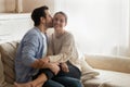 Loving boyfriend kissing girlfriend on cheek, enjoying tender moment Royalty Free Stock Photo