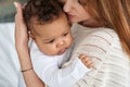 Loving caucasian mother hugging cute infant african american baby daughter. Royalty Free Stock Photo