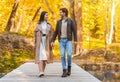 Loving cheerful couple spending time at autumn forest