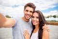 Loving cheerful happy couple taking selfie in the city