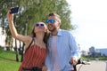 Loving cheerful happy couple taking selfie in the city