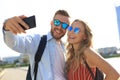 Loving cheerful happy couple taking selfie in the city