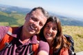 Loving cheerful happy couple taking selfie in mountain vacation
