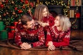 Loving family mom dad and daughter having fun near Christmas tree over decorated living room Royalty Free Stock Photo