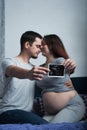 Loving couple in anticipation of baby is holding ultrasound scan.. Royalty Free Stock Photo