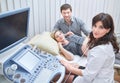 Loving couple attending doctor for pregnancy ultra sound procedu