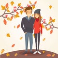 Loving couple in autumn amid falling leaves.