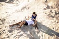 Loving couple on the beach in the sand hugging. The concept of love and a date at sea Royalty Free Stock Photo