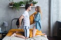 Loving couple in the bedroom having pillow fight. Royalty Free Stock Photo