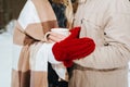 Loving couple with blanket hugs in winter forest, outdoors. Royalty Free Stock Photo